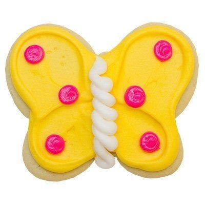 A cookie in the shape of a butterfly with yellow frosting and pink buttons.