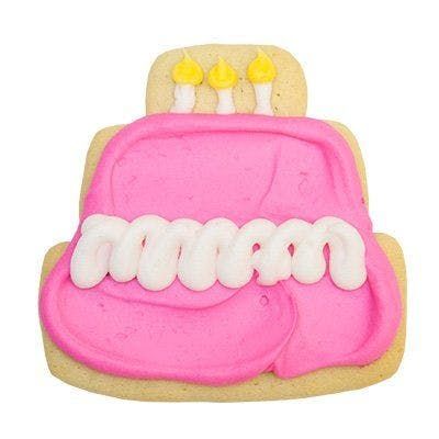 A cookie decorated to look like a birthday cake with pink frosting and yellow candles.