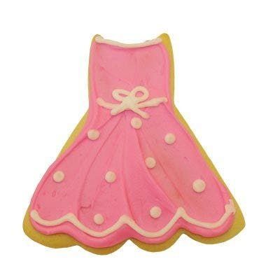 A cookie in the shape of a pink dress with white frosting.
