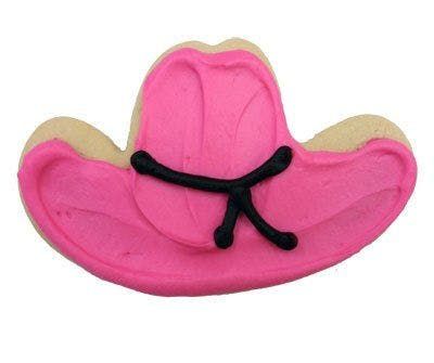 A pink cowboy hat cookie with a black string