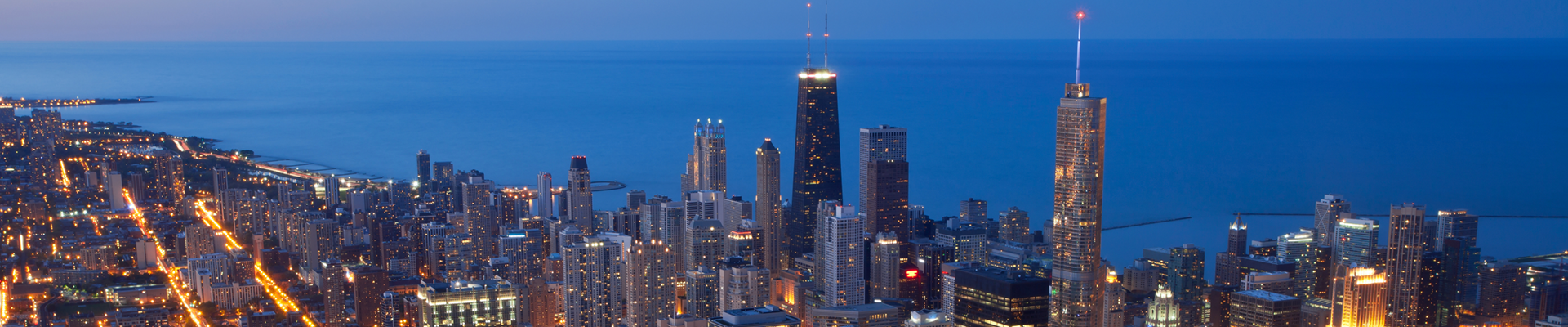 A blurry picture of a city skyline at night.