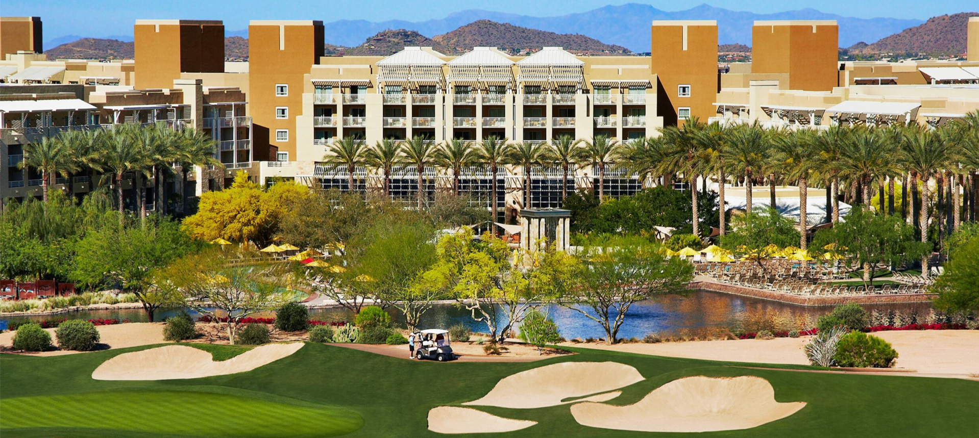 A golf course with a large building in the background