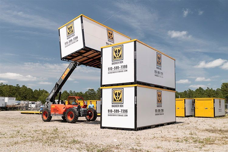 a forklift is lifting a stack of badger box containers