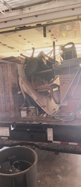 A pile of junk is sitting on top of a trailer.