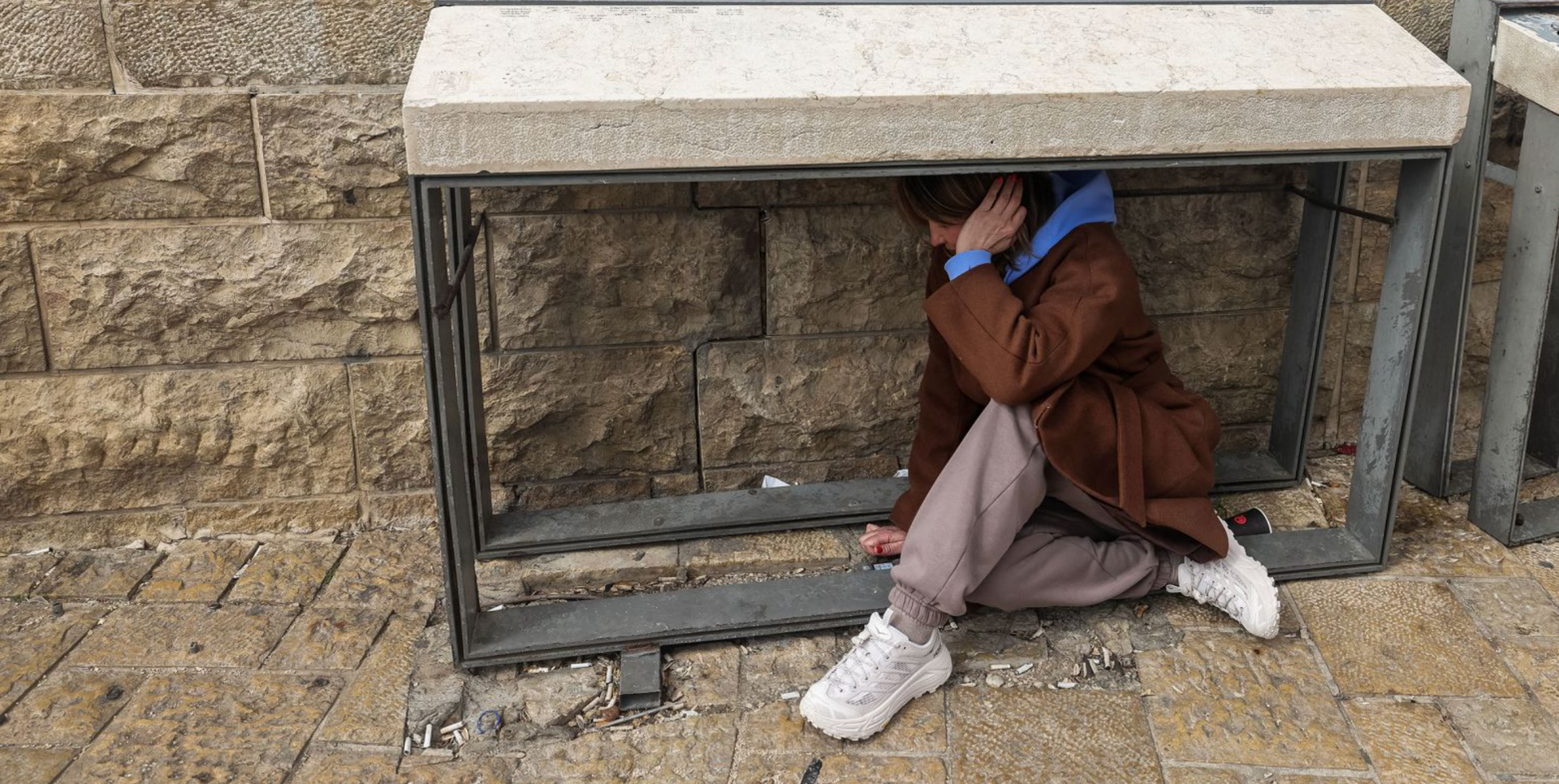 Women taking shelter in the most available place during the missile attack.  