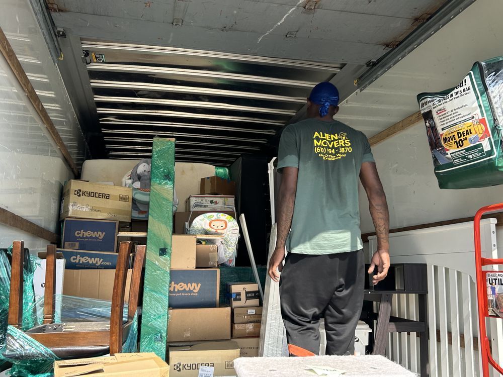 Alien Movers' professional ensuring secure and organized junk removal from a packed truck, demonstrating meticulous service for clients in Philadelphia.