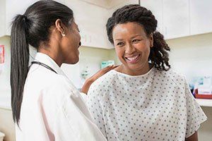 Smiling Woman Facing A Woman Doctor — Surgical Procedure in Monterey,CA