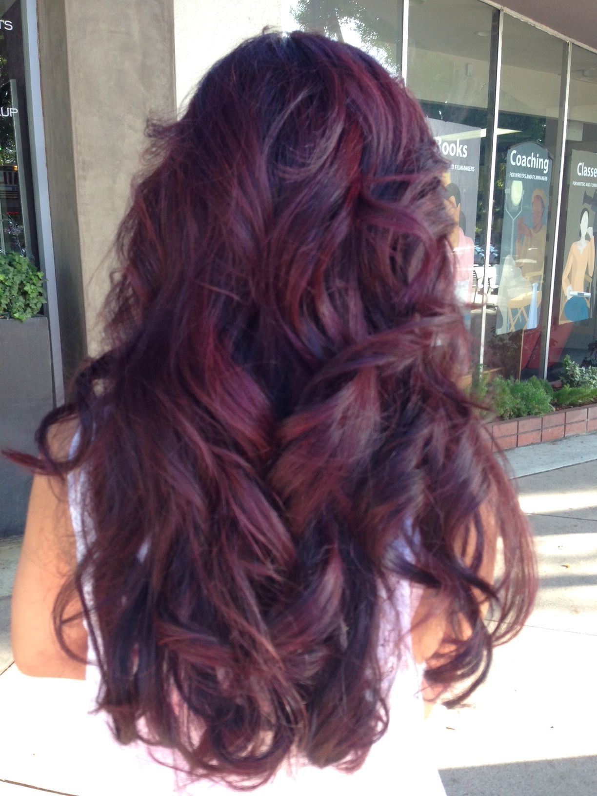 Person getting hair dye applied with a brush by someone wearing gloves.