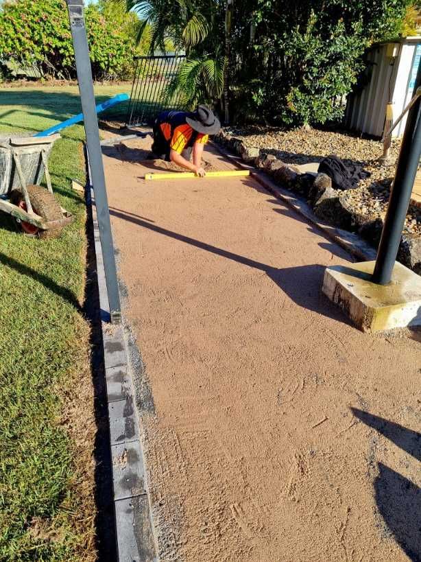 Stone Paved Patio With Circular Border Around a Green Bush — On The Mark Landscaping in Branyan, QLD