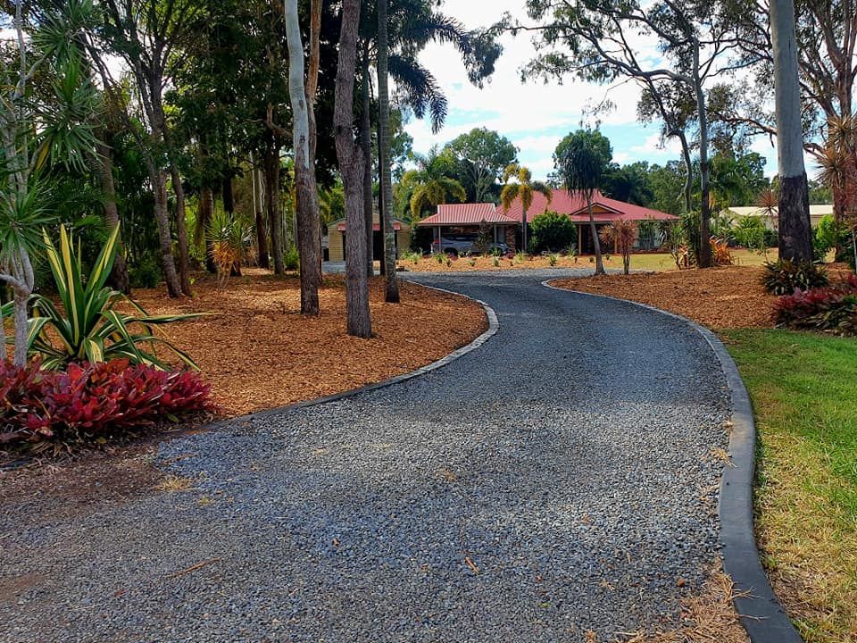 Gravel Driveway Curving to a Building Surrounded by Trees and Landscaping — On The Mark Landscaping in Branyan, QLD