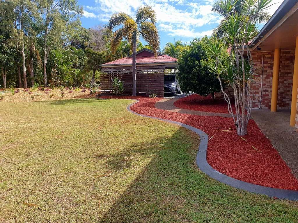 A Well-manicured Lawn With a Red Mulch Pathway — On The Mark Landscaping in Elliot Heads, QLD