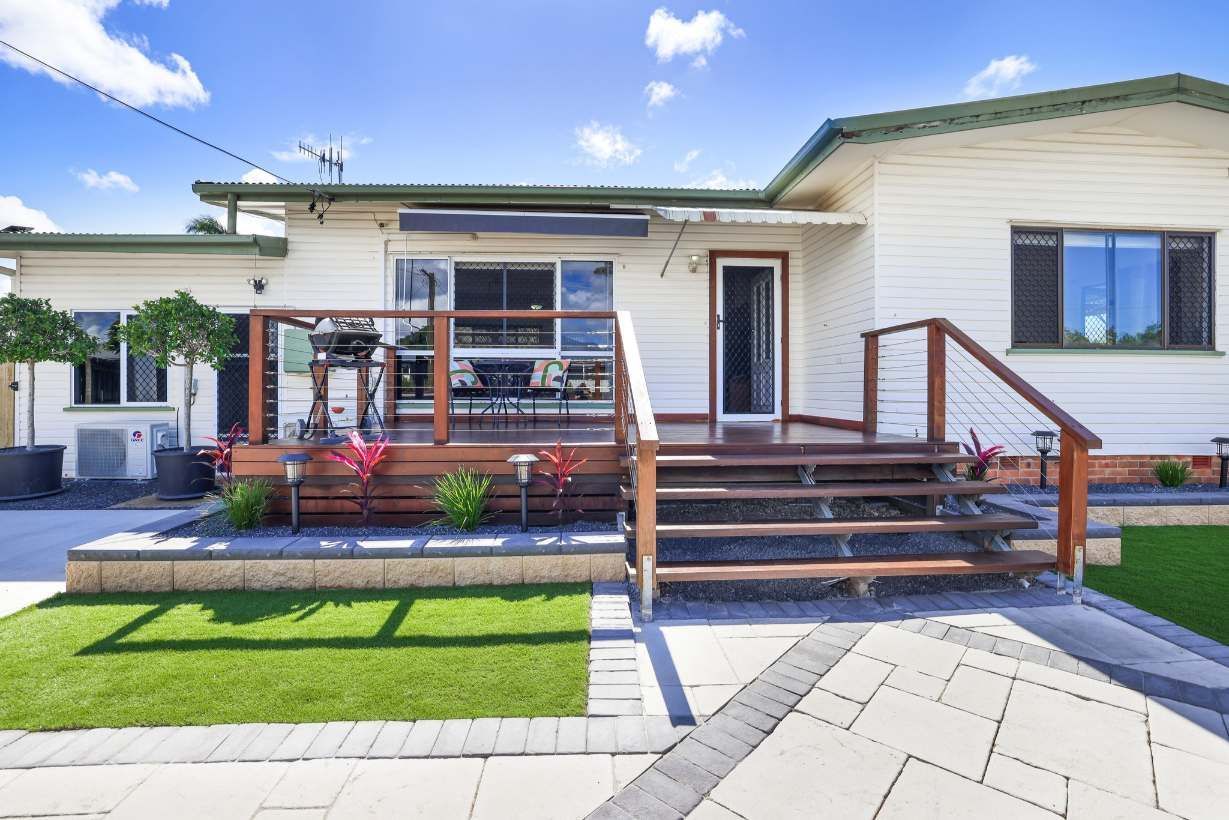 House Exterior With a Wooden Deck, Steps, and Lawn — On The Mark Landscaping in Branyan, QLD