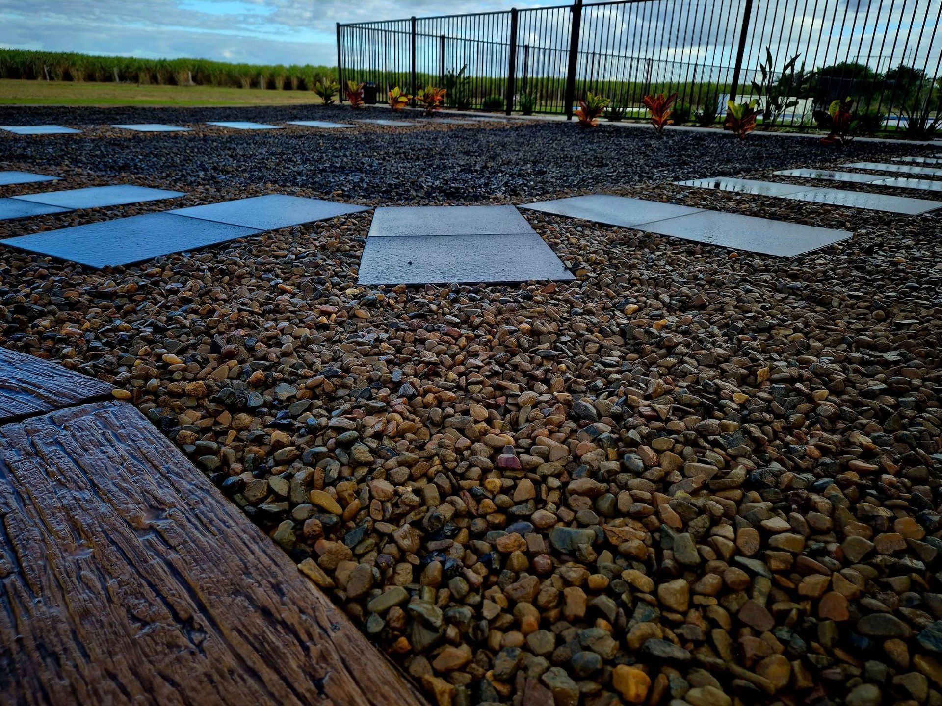 Stone Path With Rectangular Pavers and Gravel, Leading to a Fence and Vegetation — On The Mark Landscaping in Branyan, QLD