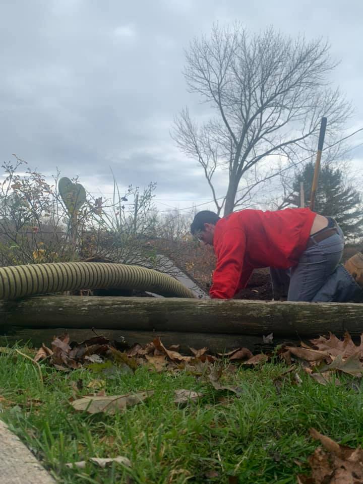 Worker Putting Septic Hose — Mahopac, NY — Evans Septic Tank Service