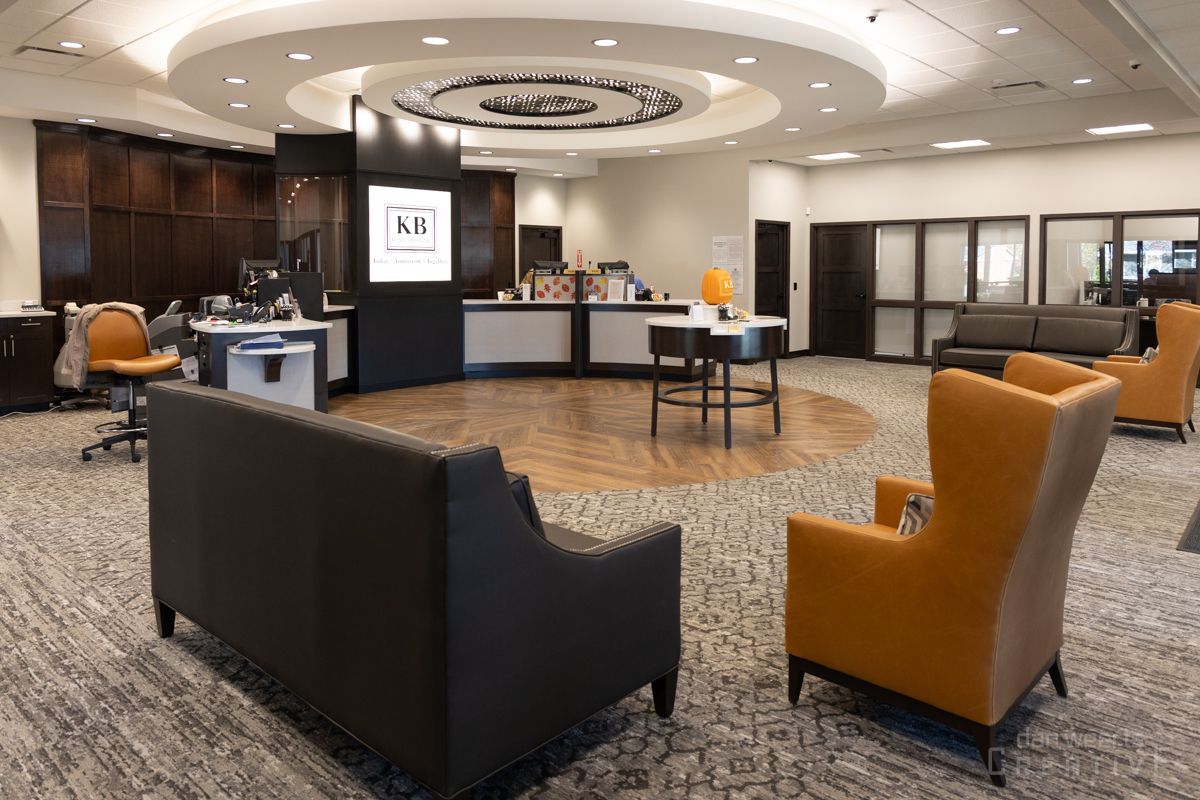 A large room with a couch and chairs in it