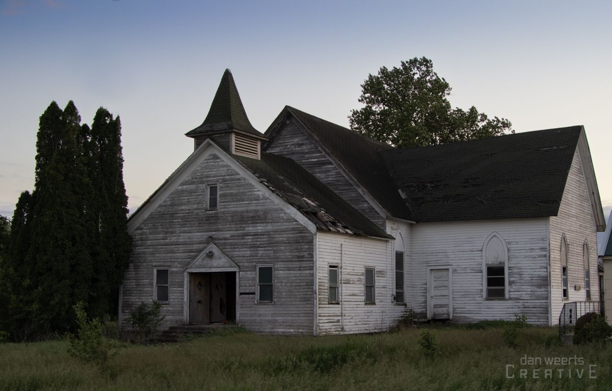An old wooden building with the word creative on the bottom