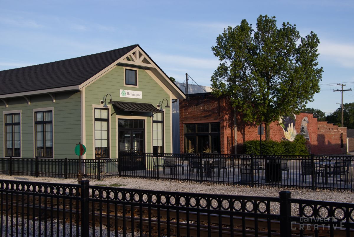 A green building with a sign that says ' Remington ' on it