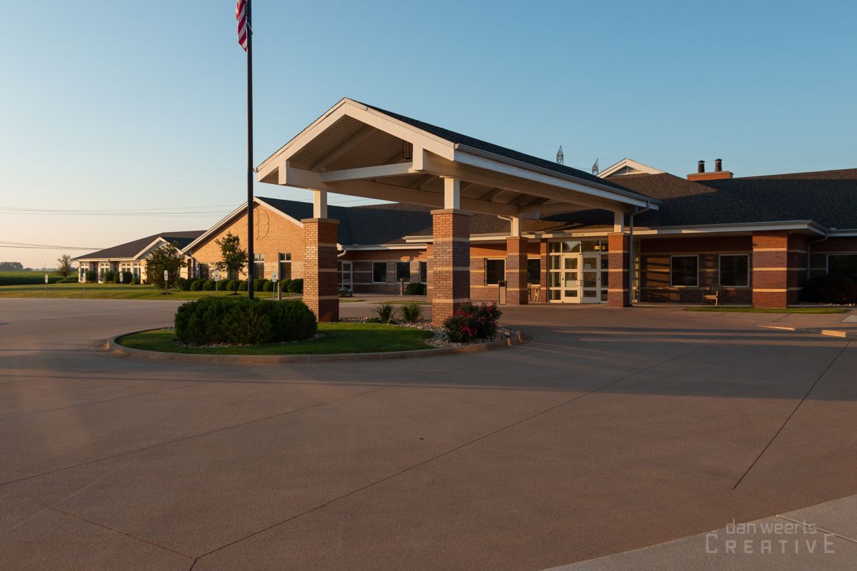 A large brick building with a flag in front of it