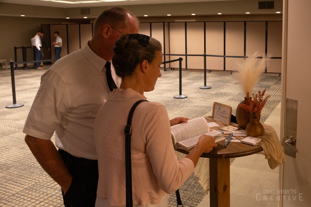 A man and a woman are standing next to each other in an empty room.