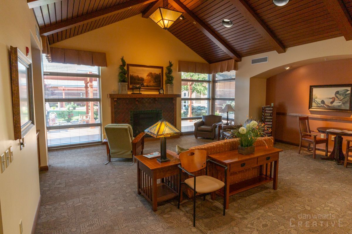 A living room with a fireplace and a lamp
