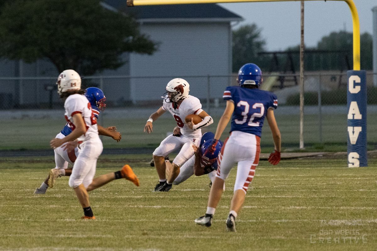 A football player with the number 32 on his jersey is running with the ball.