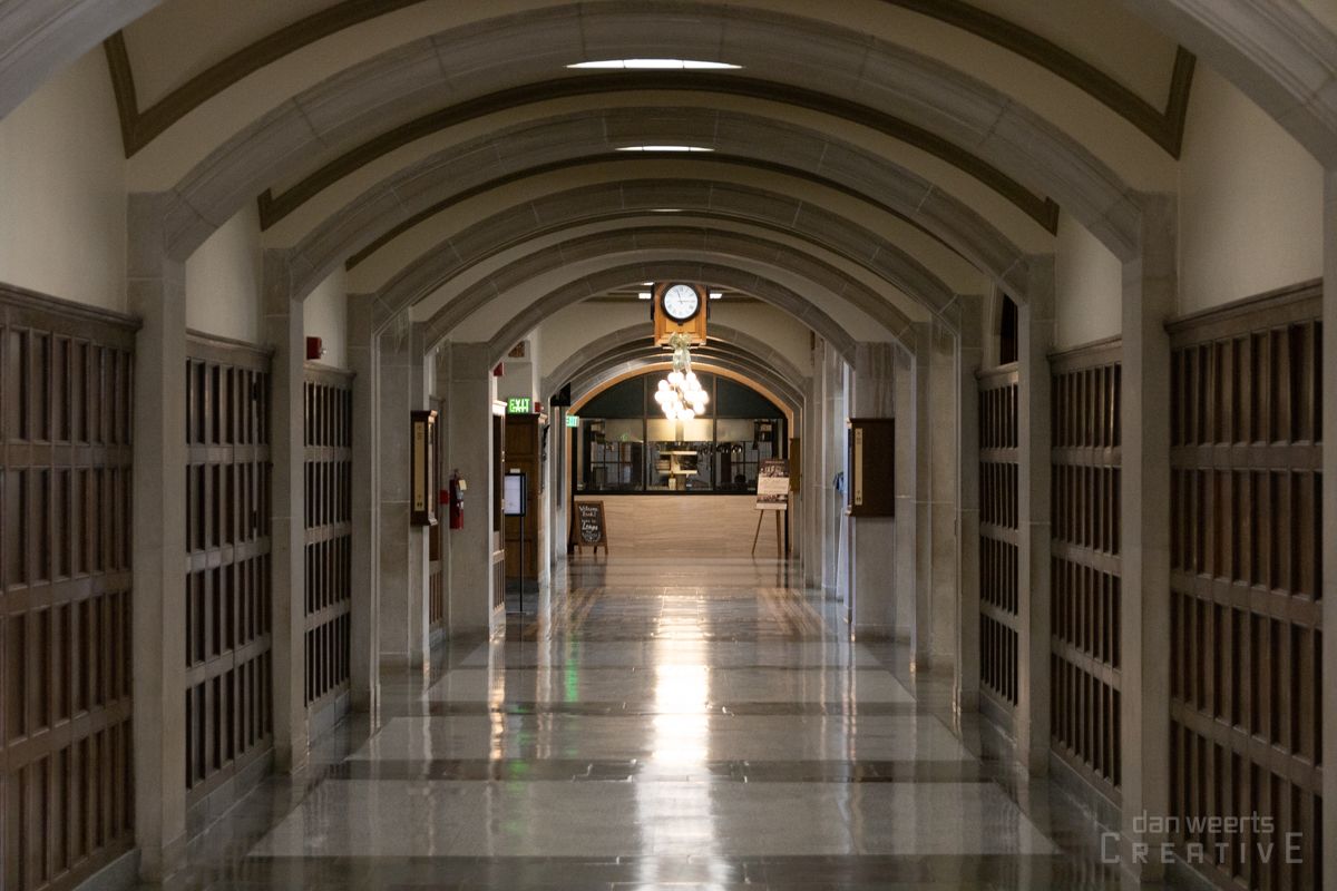 A long hallway with a clock on the ceiling