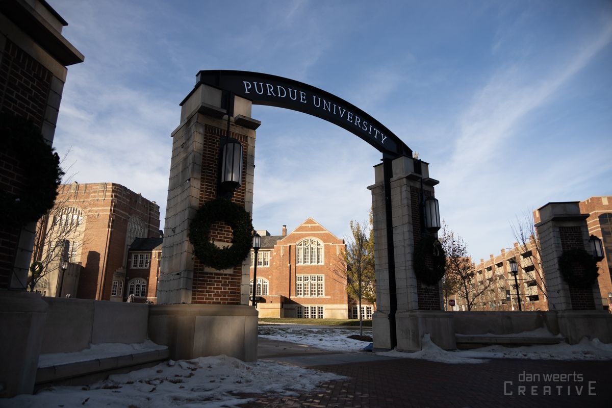 A brick building with a sign that says ' Purdue University' on it