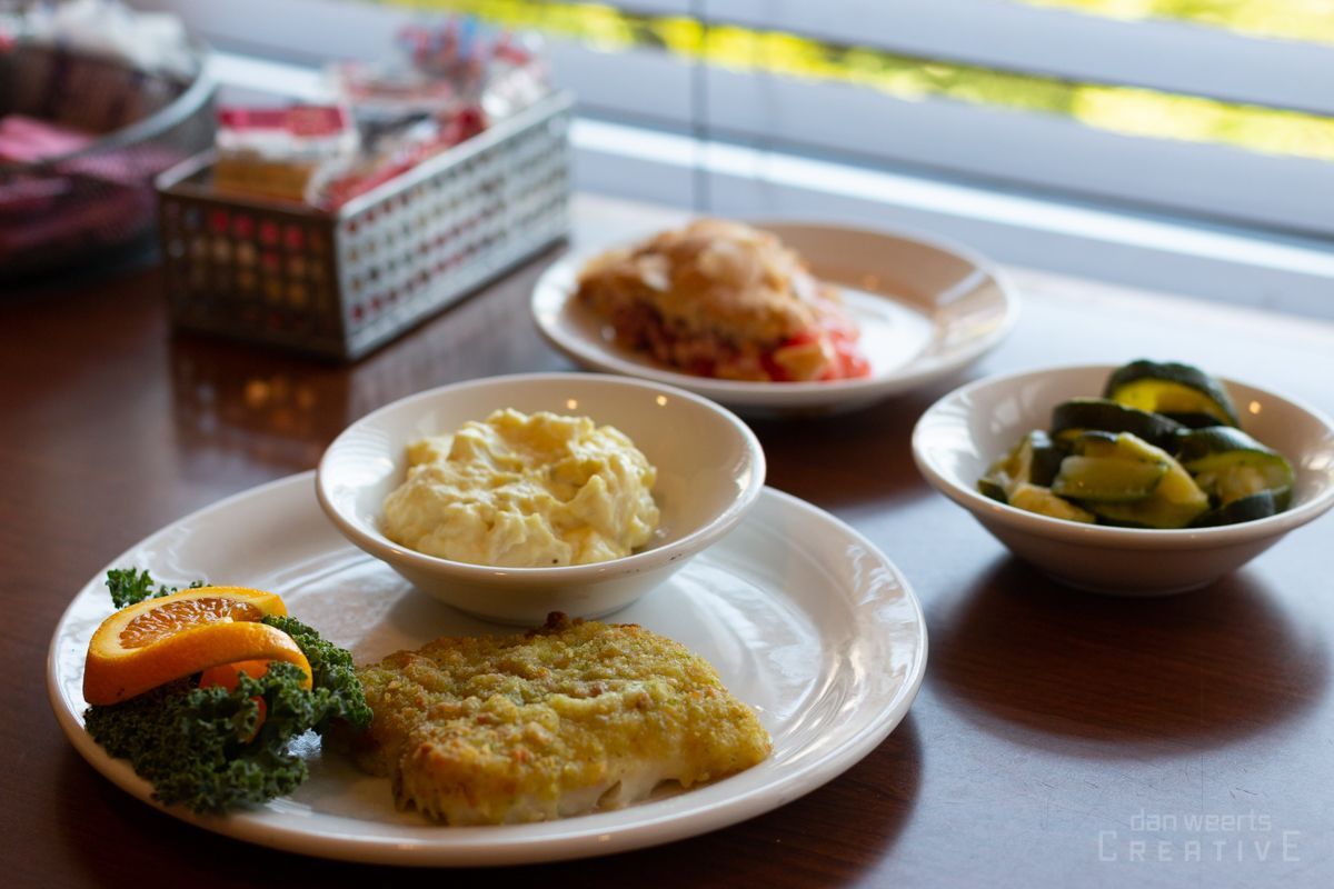 A table topped with plates of food and bowls of vegetables.