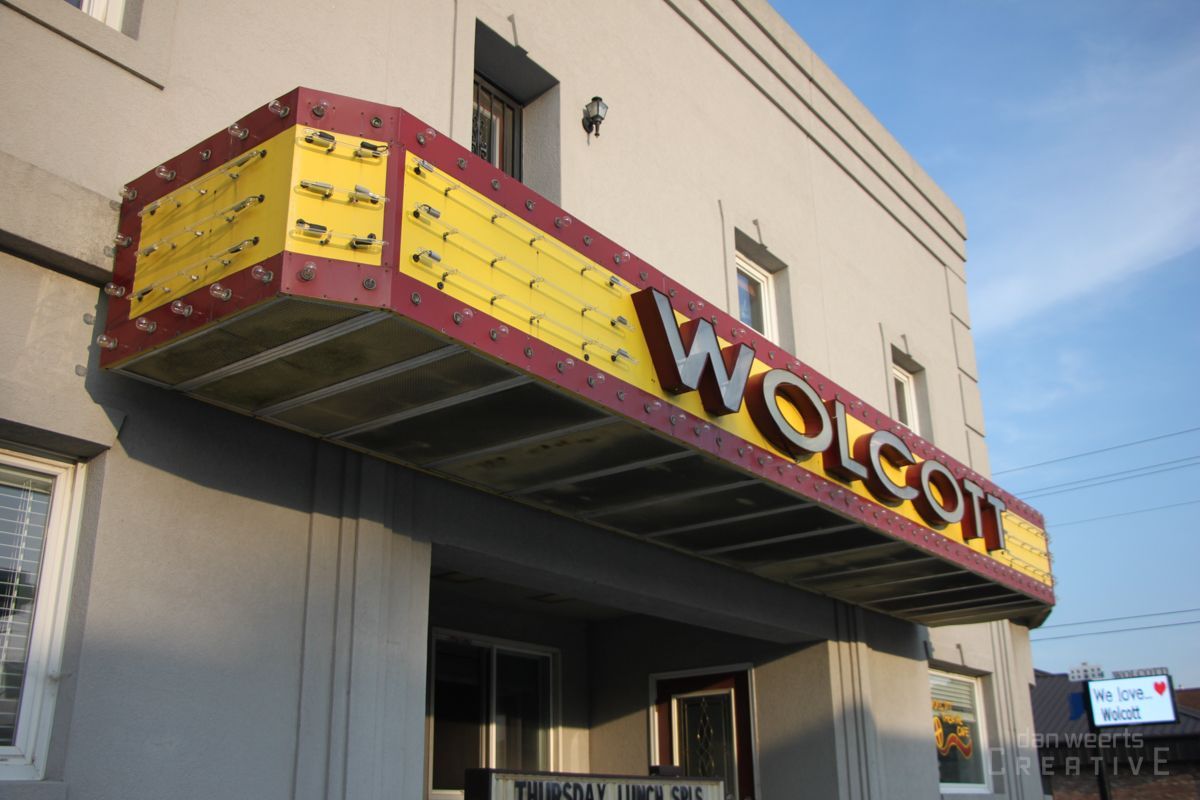 A building with a sign that says wolcott on it