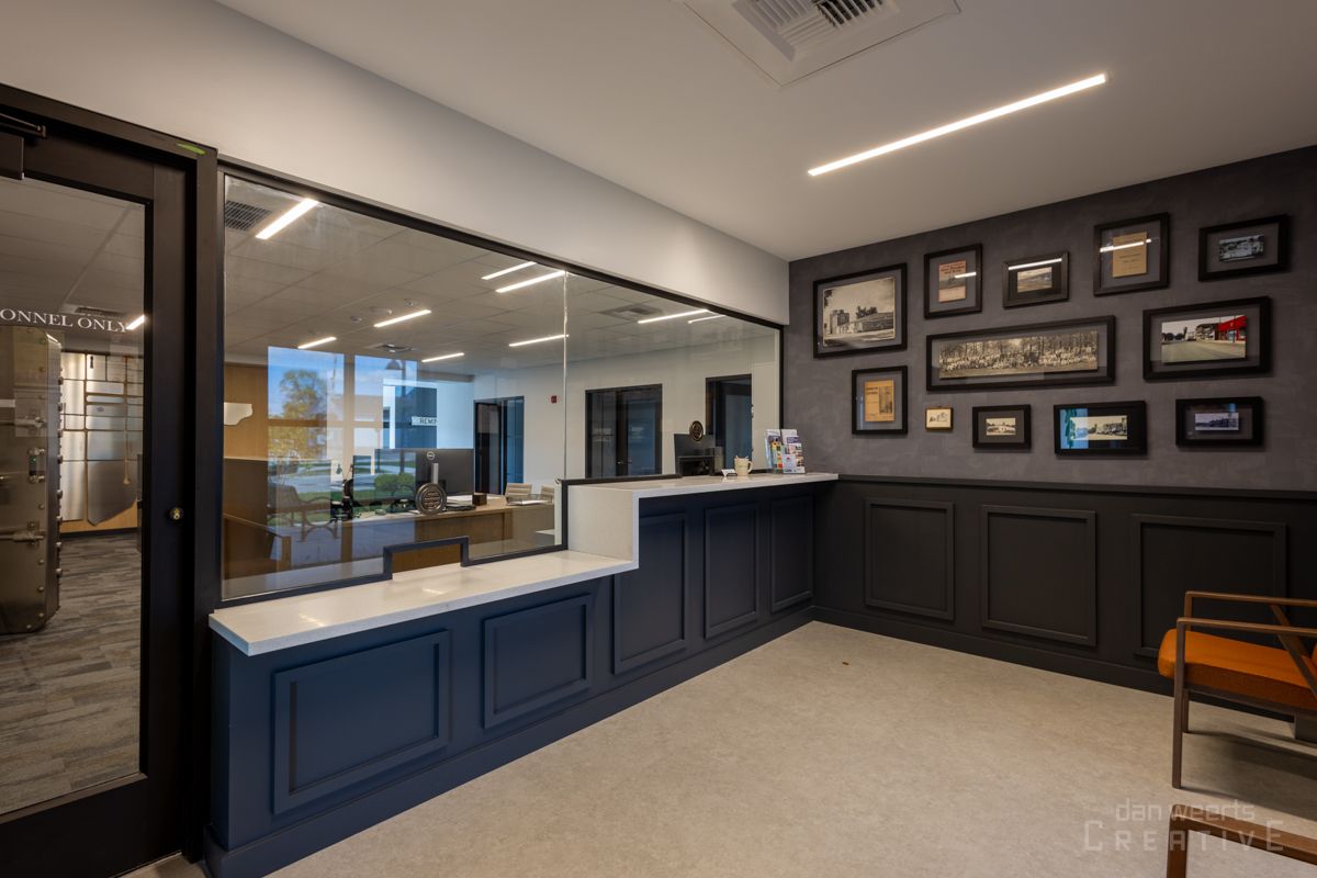 A waiting room with a glass wall and a counter.