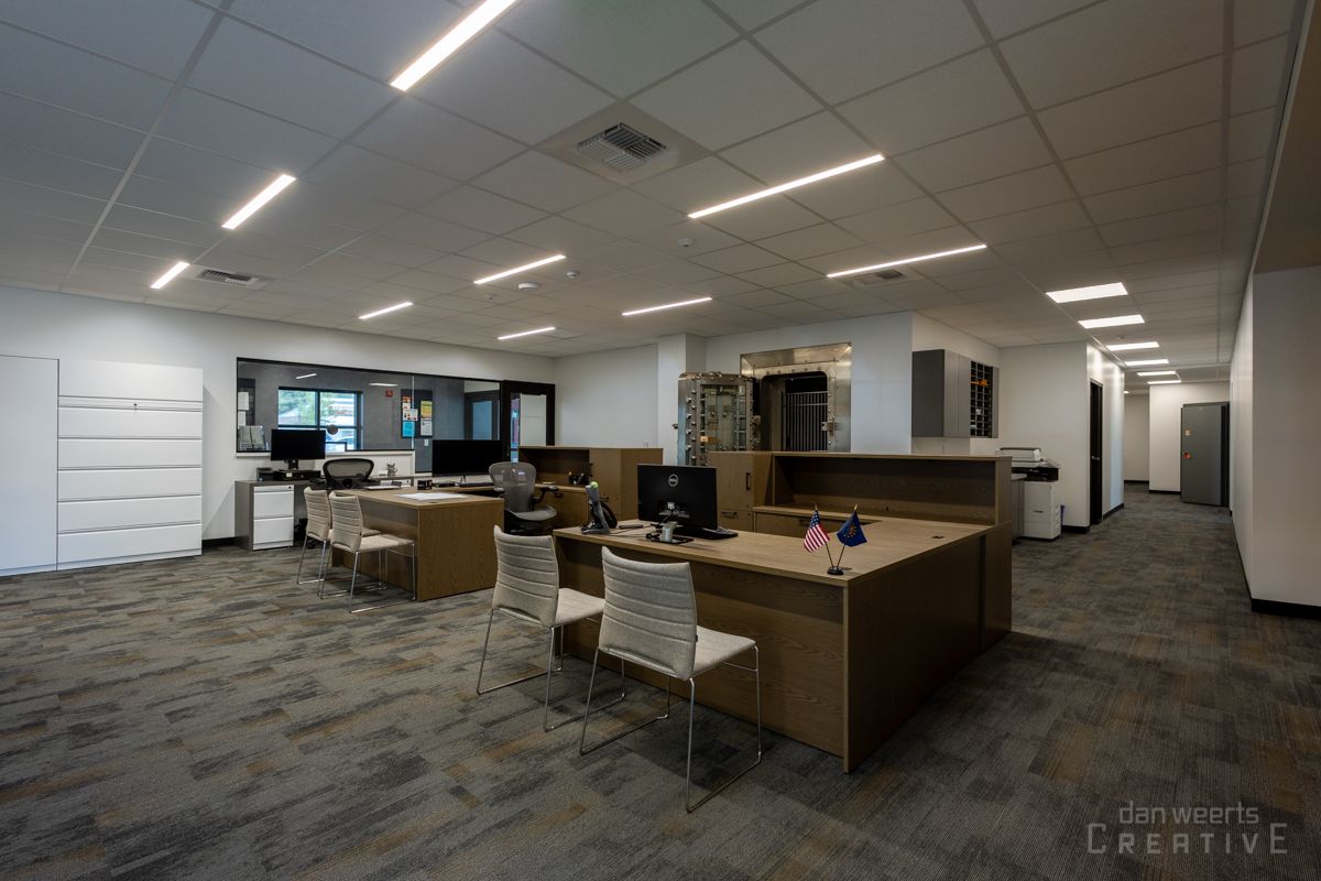 A large office with a lot of desks and chairs.