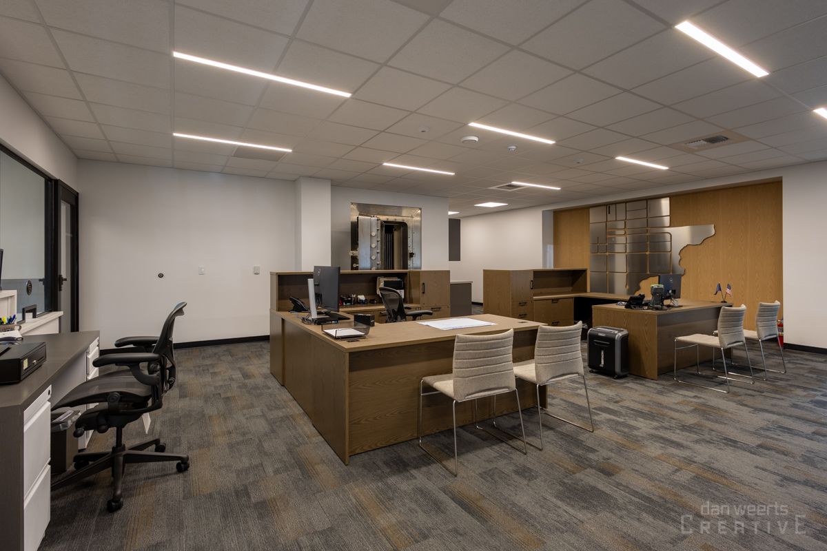 A large office with a lot of desks and chairs.