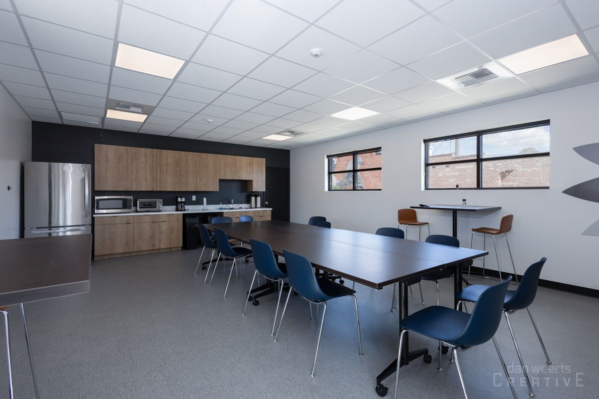 A large room with a table and chairs in it
