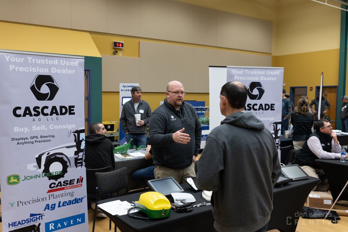 A man is standing in front of a sign that says cascade