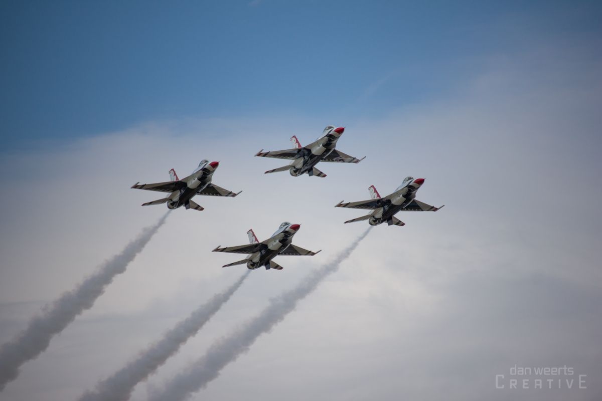 Four fighter jets are flying in formation in the sky.