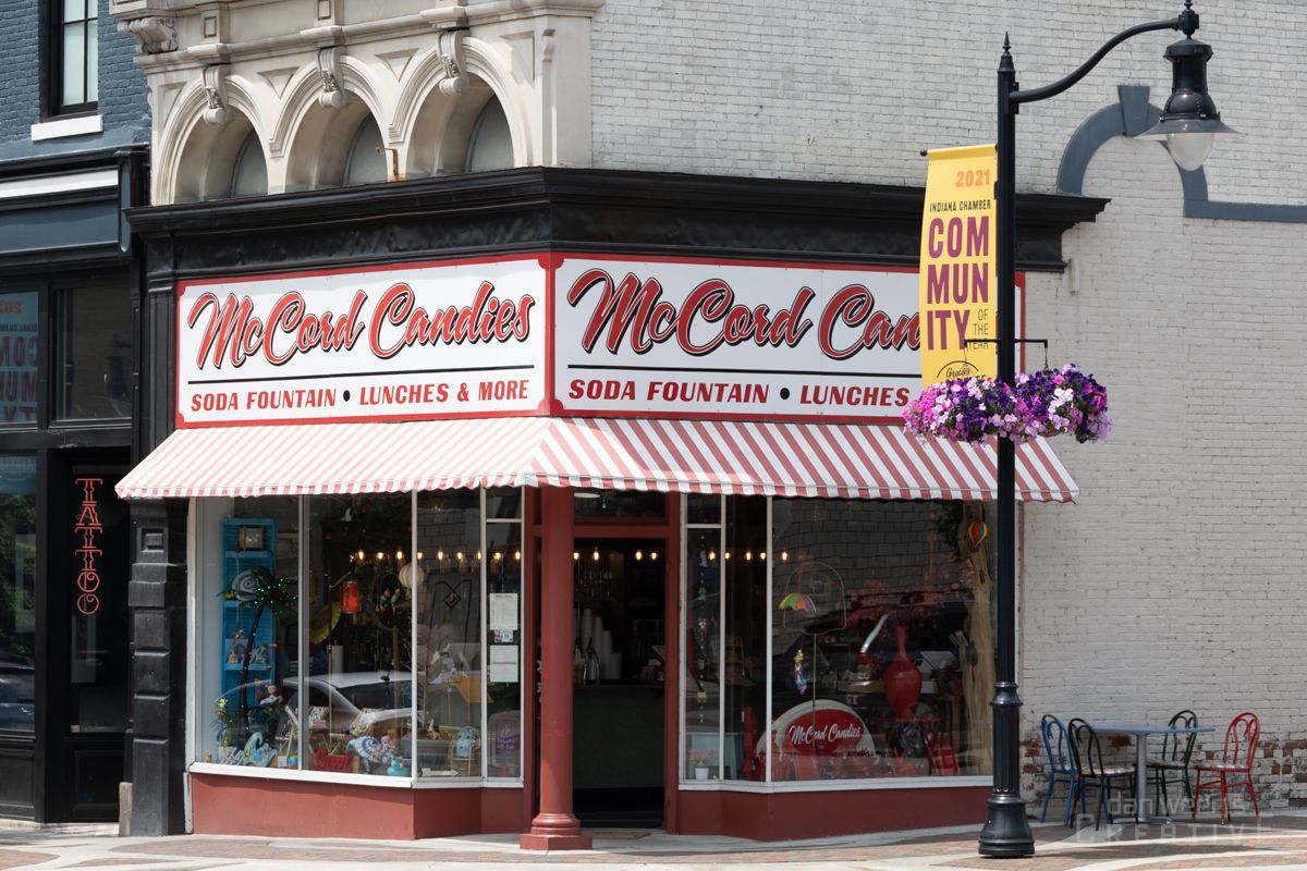 A store front with a sign that says ' McCord Candies ' on it