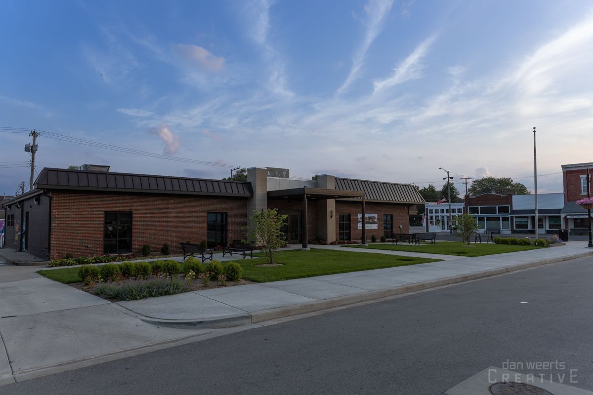 A group of buildings are sitting next to each other on the side of a street.
