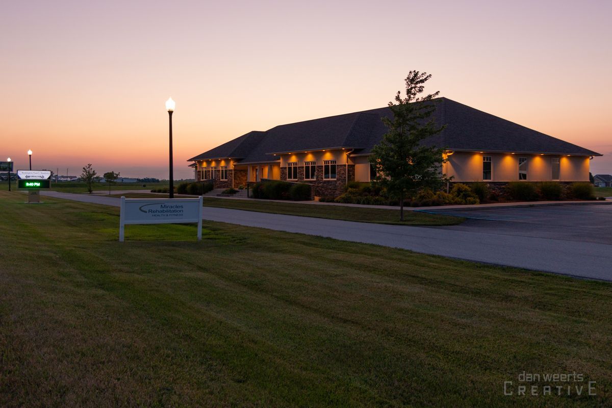 A large building with a sunset in the background