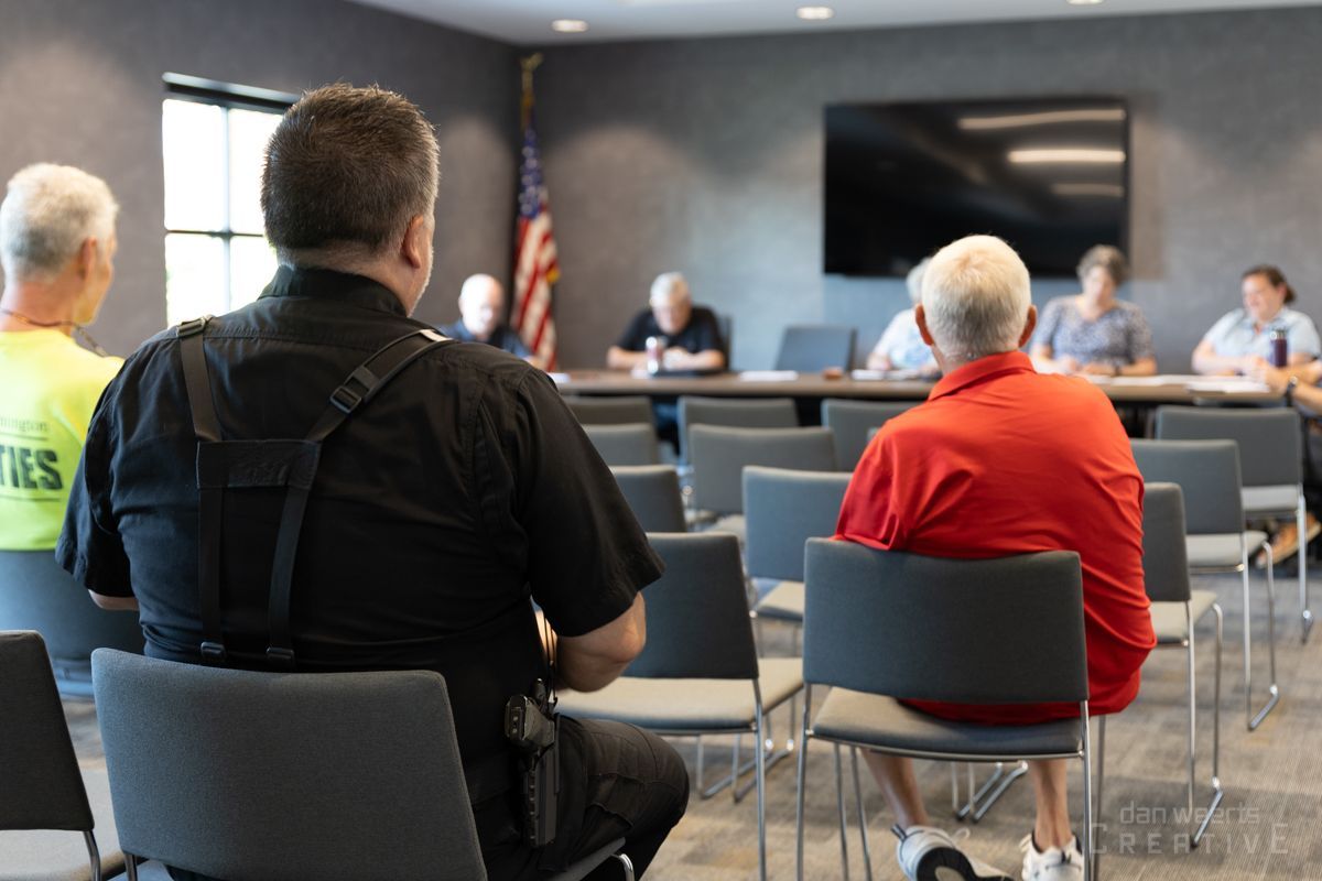 A group of people are sitting in chairs in a room.