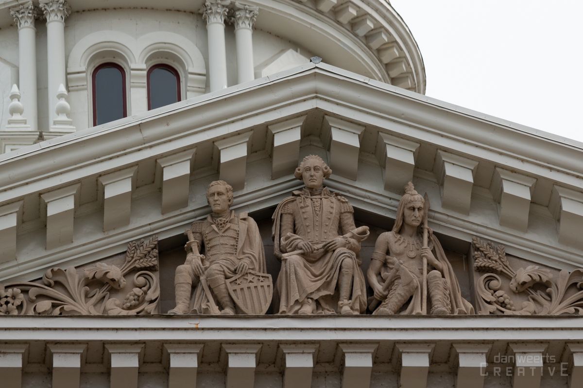 A statue of george washington is on the front of a building