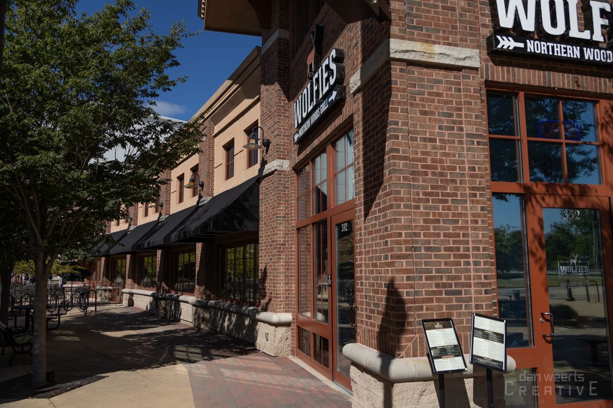 A brick building with a sign that says wolfies on it