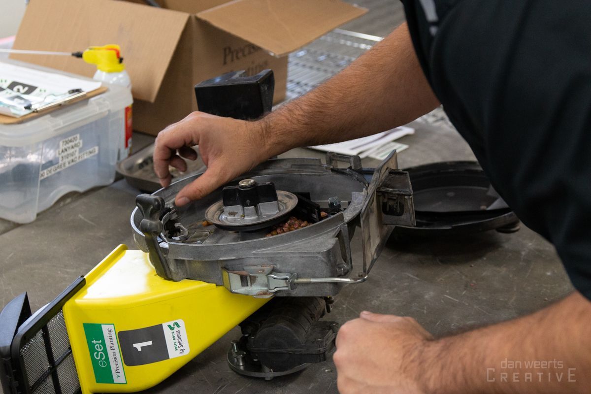 A man is working on a planter on a table.