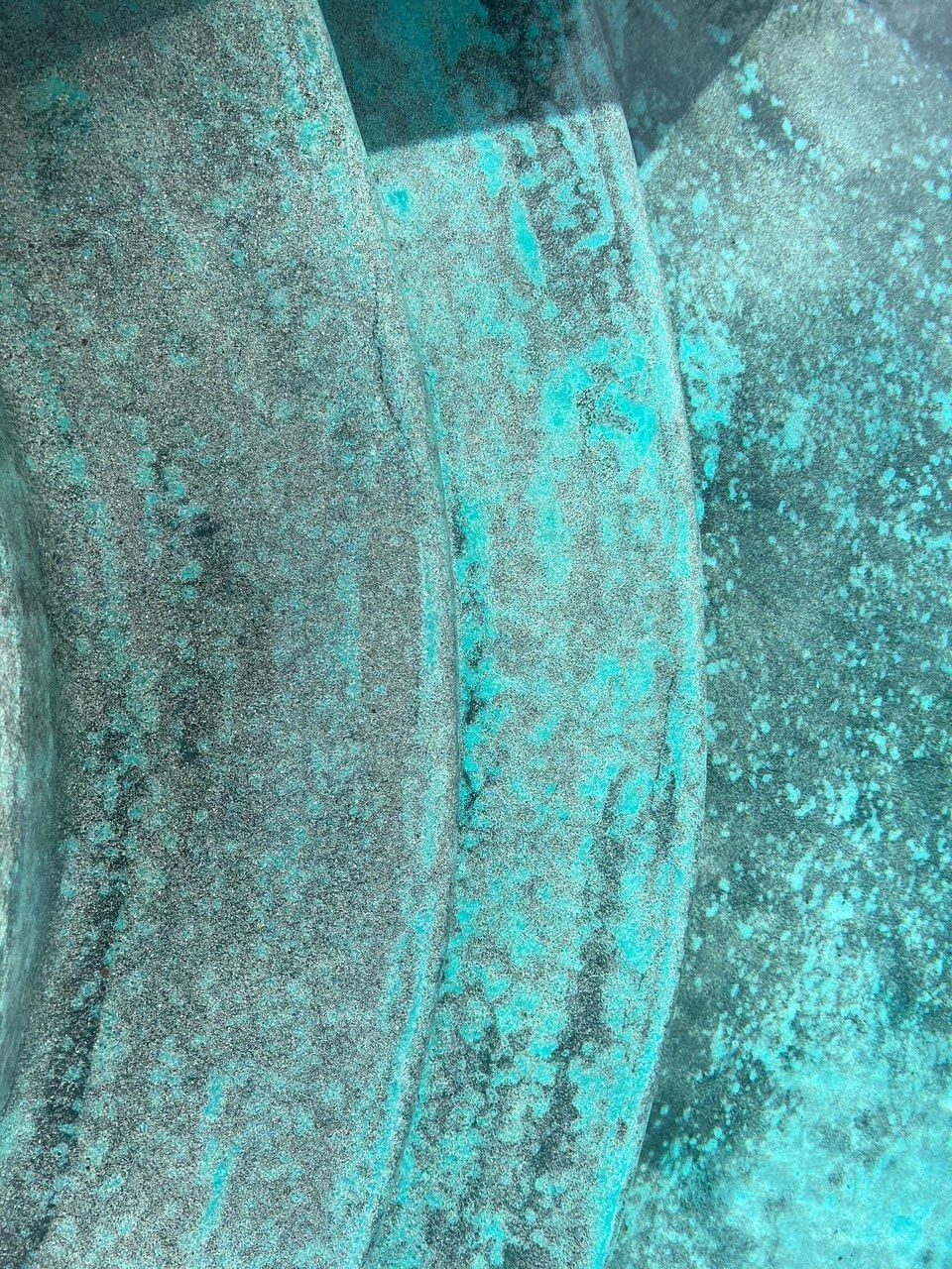 A close up of a turquoise and gray surface.