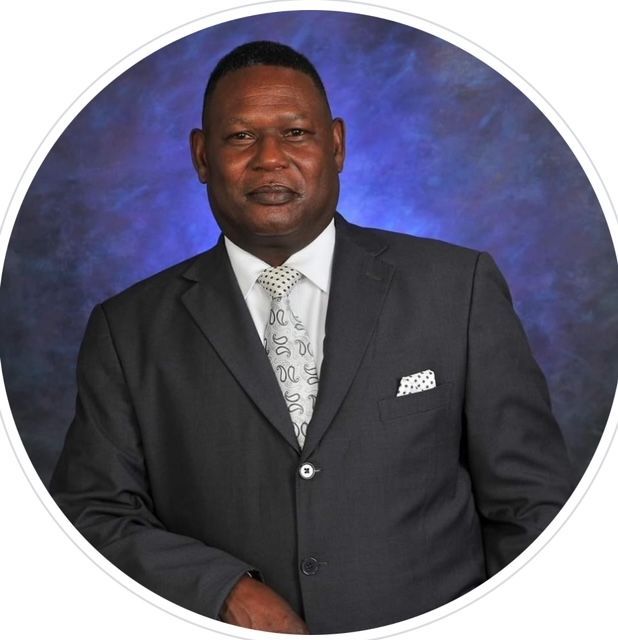 A man in a suit and tie is standing in a circle