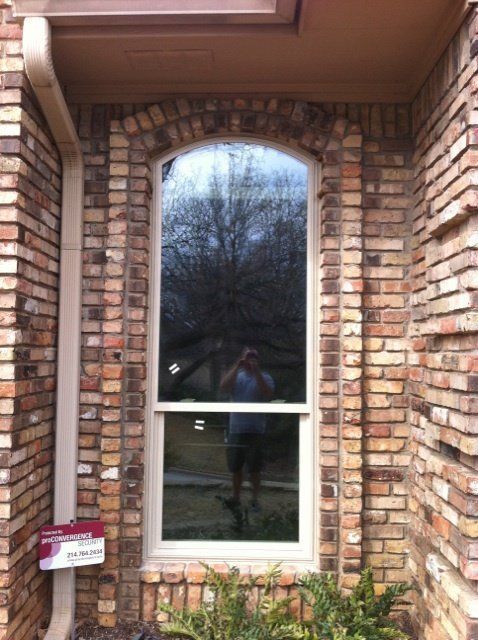 A man taking a picture of himself in a window