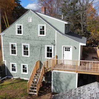 An aerial view of a house with a deck and stairs