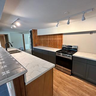 A kitchen with a stove top oven and a sink