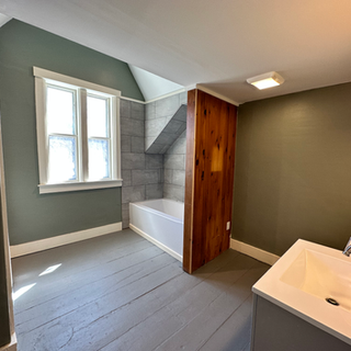 A bathroom with a bathtub and a sink