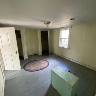 There is a rug on the floor in the middle of the room.