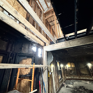 The inside of a building under construction with a ladder